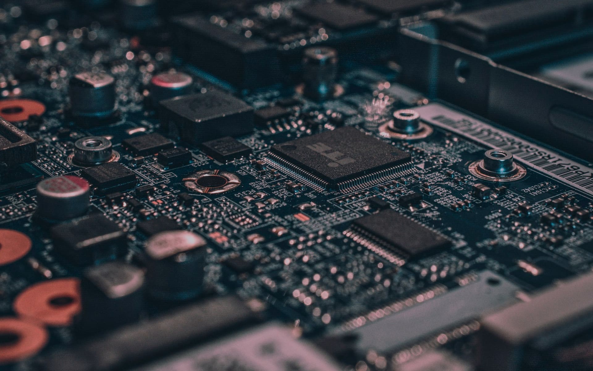 Close-up of server circuit boards glowing in a dark rack
